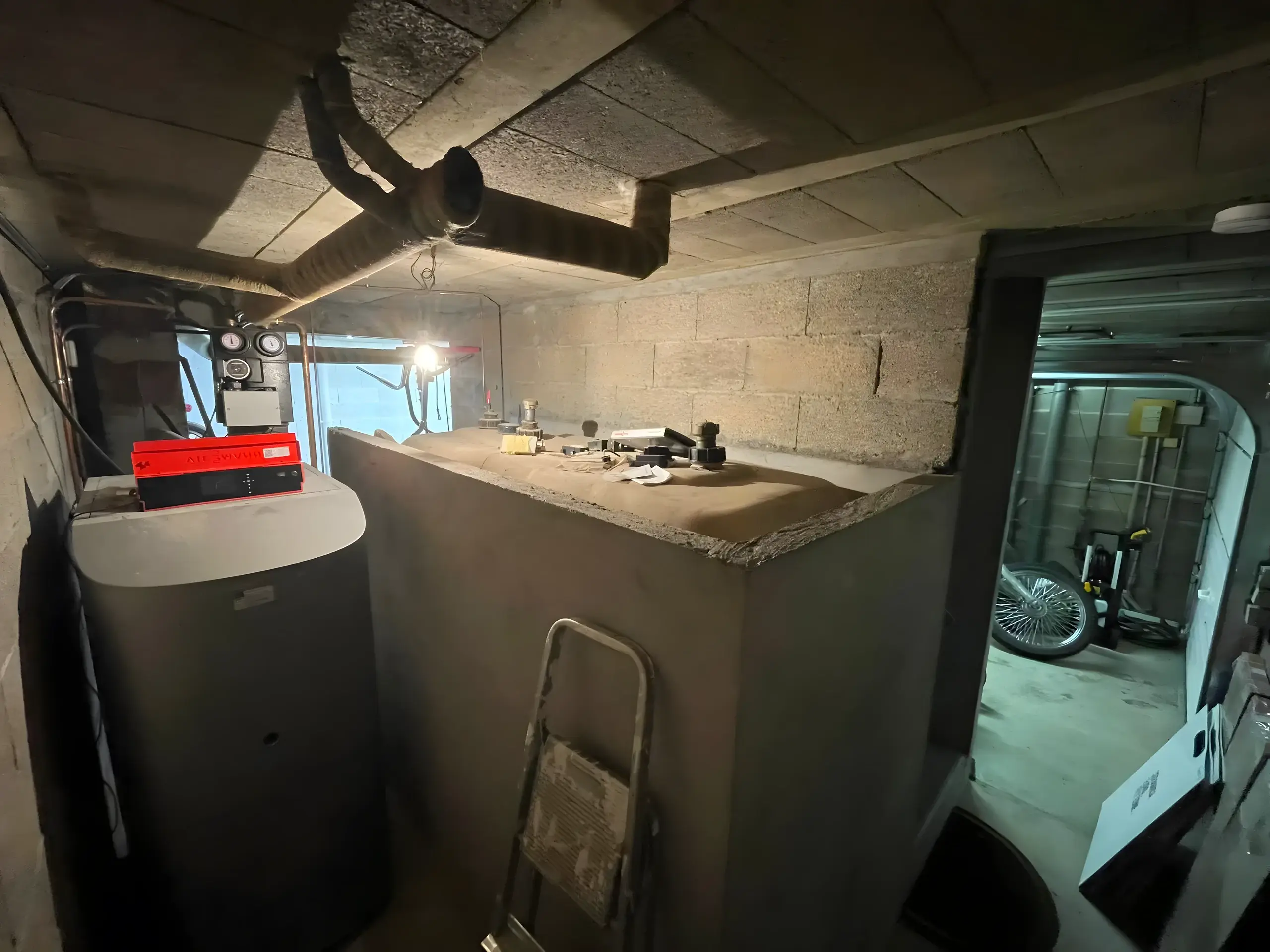 Chaufferie mazout d'une villa genevoise avant remplacement : chaudière, brûleur et citerne